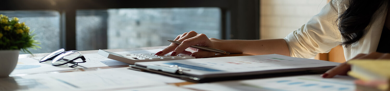 Close up a accountant working about financial with calculator at office to calculate expenses, Accounting concept