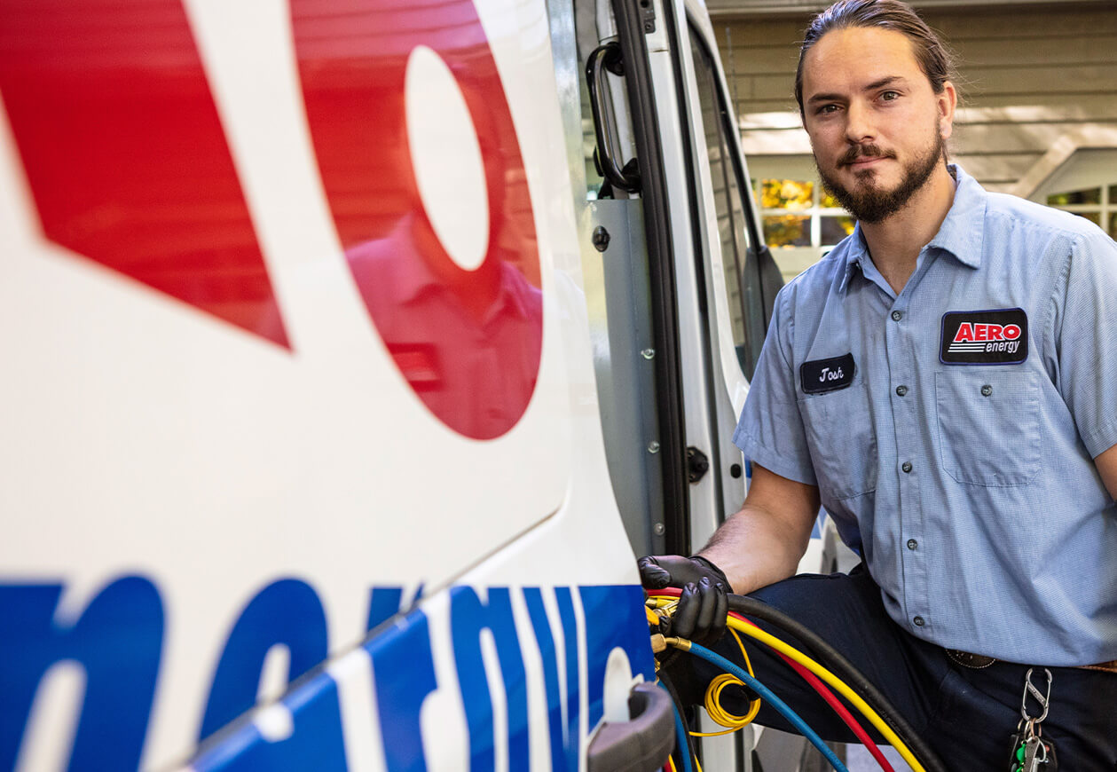 Technician grabs tools from inside van.