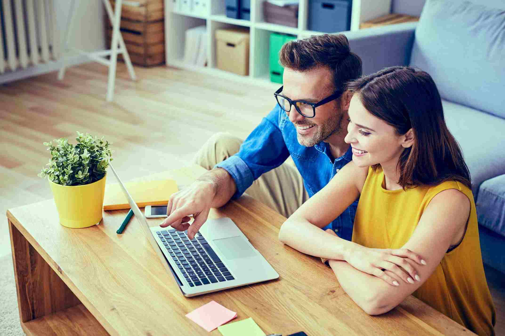 Happy,Couple,With,Laptop,Spending,Time,Together,At,Home