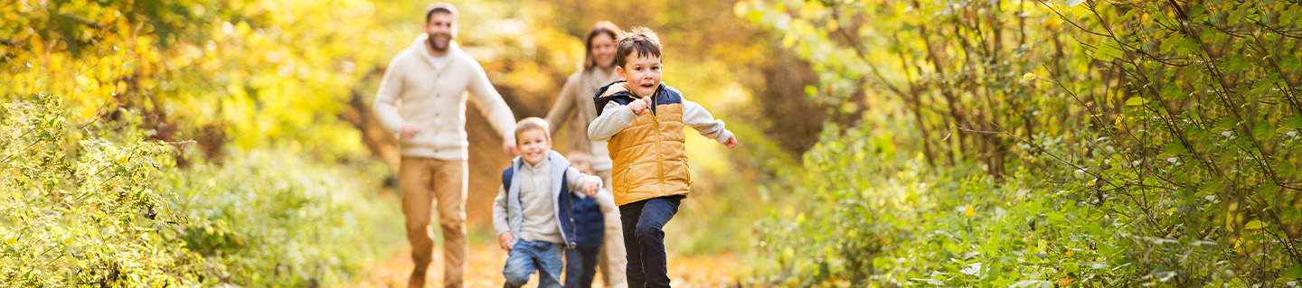 Family goes on a walk during the fall season.