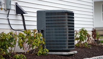 AC unit sits outside house.