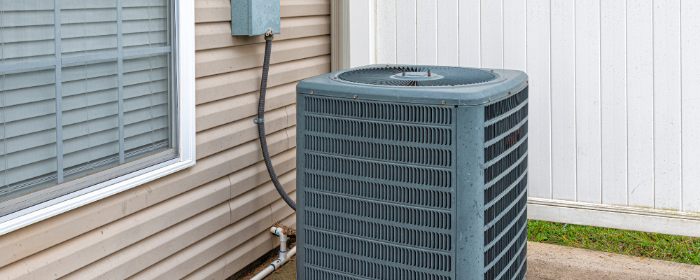 HVAC unit sits next to a home.