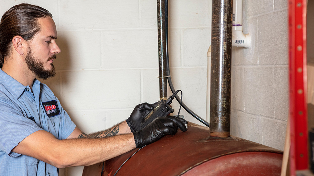 Aero Energy technician inspects a heating oil tank.