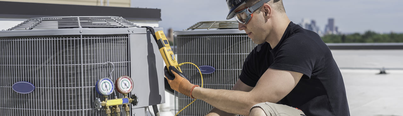 Hvac tech looking at a multimeter