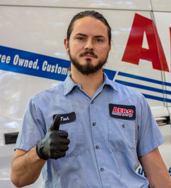 Aero Energy technician stands smiling.