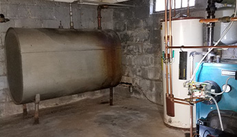 Oil tank sits in a basement.