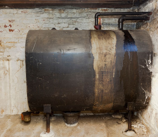 Old heating oil tank in dingy dank basement