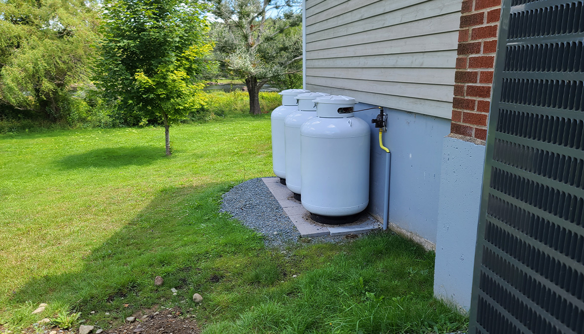 Propane tanks sit adjacent to a home