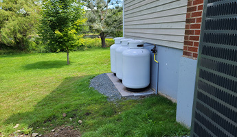 Propane tanks sit next to a home.