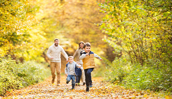 Family takes a walk in the fall season.