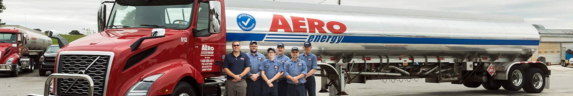 mens standing in front of aero tanker